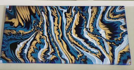 Fluid art painting with teal, gold, and white swirling patterns